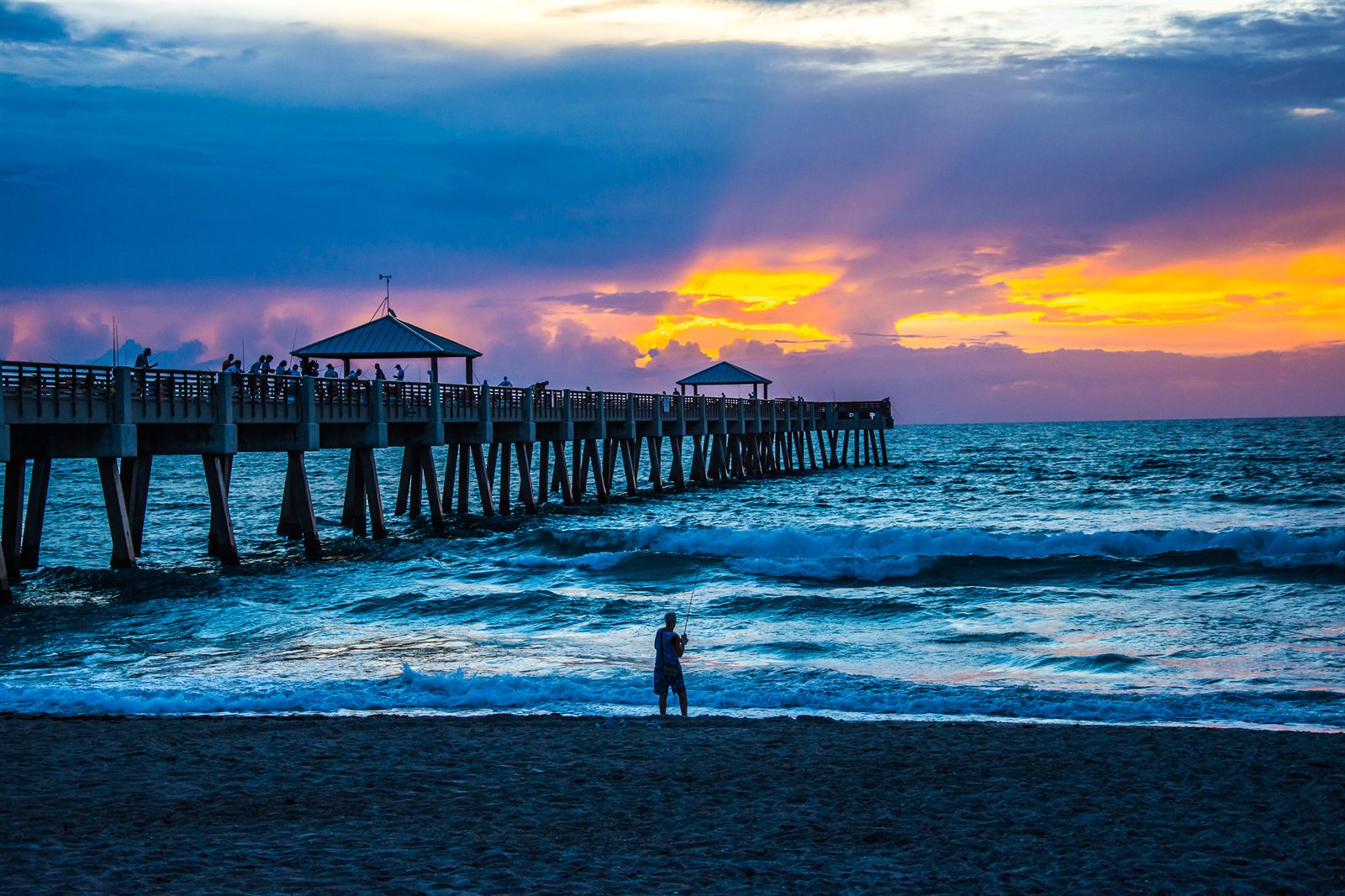 Fishing pier stretching into the Atlantic at sunrise