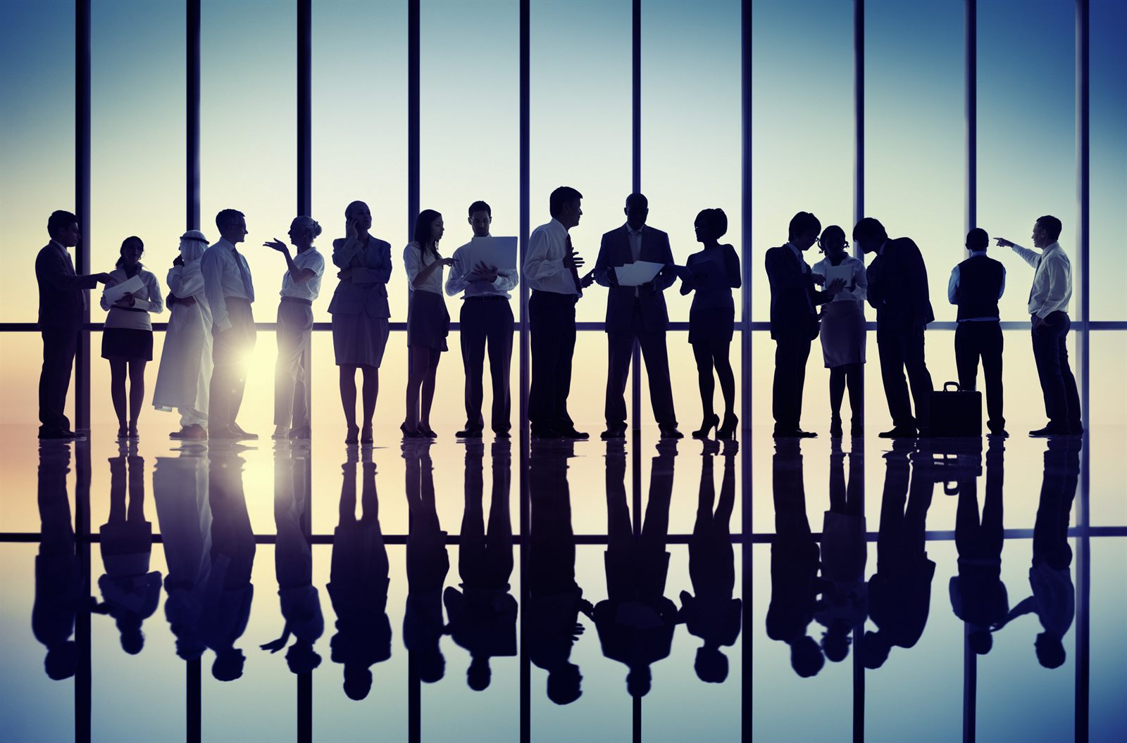 Silhouettes of a large group of people standing together at a window, like members of a cruise club