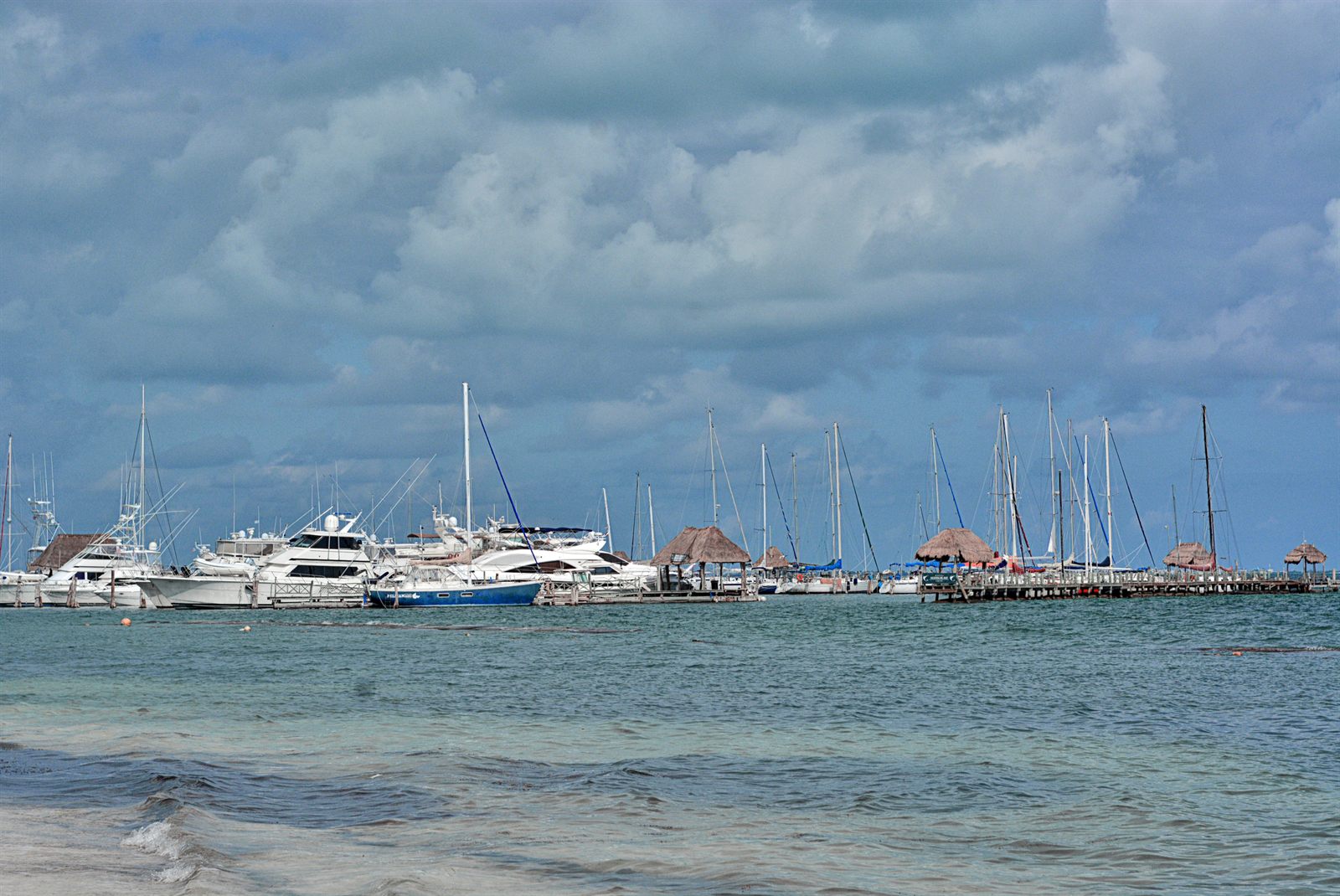 Marina full of boats under a cloudy Florida sky